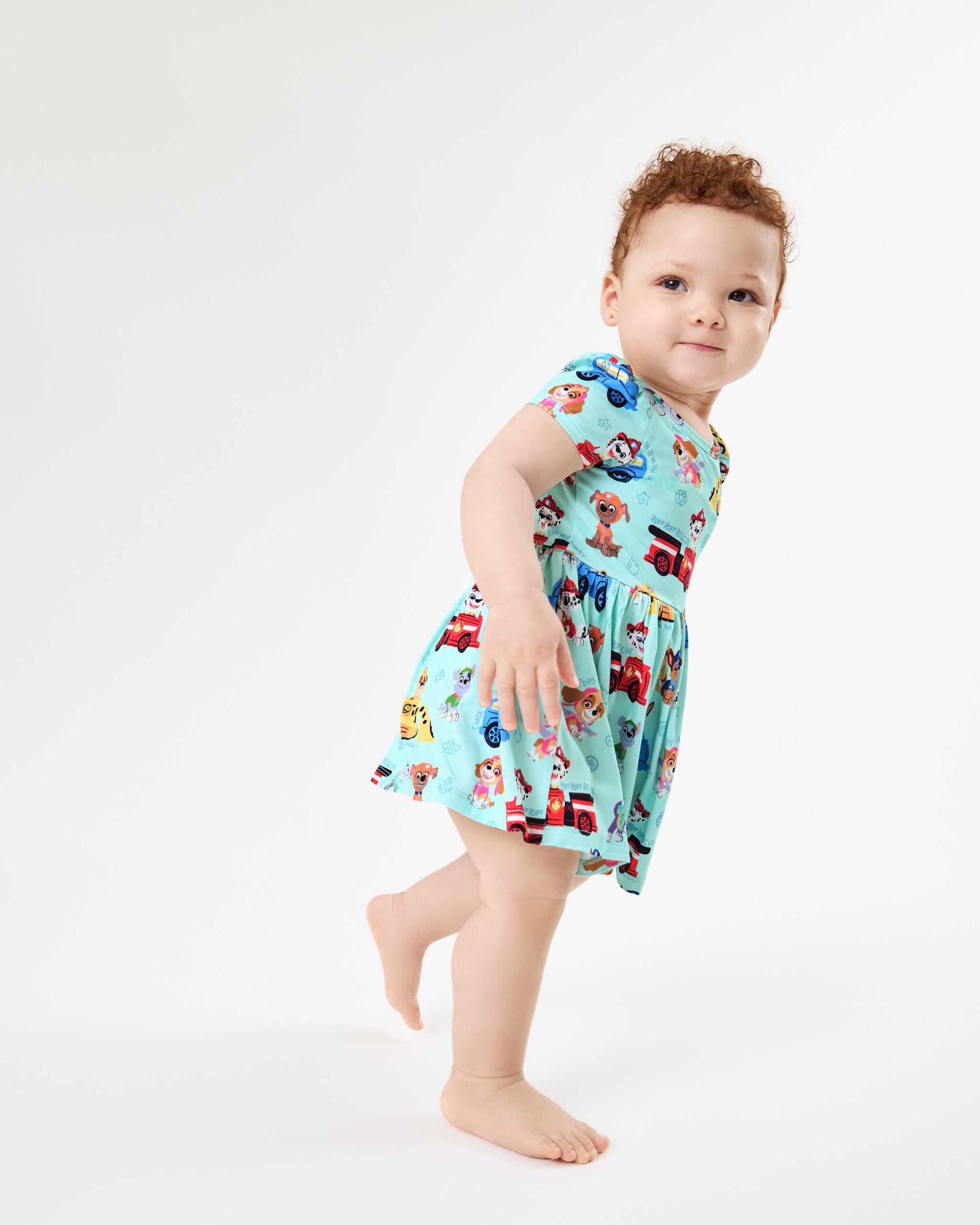 Walking toddler wearing the PAW Patrol Adventure Bay Heroes Skater Dress with Bodysuit