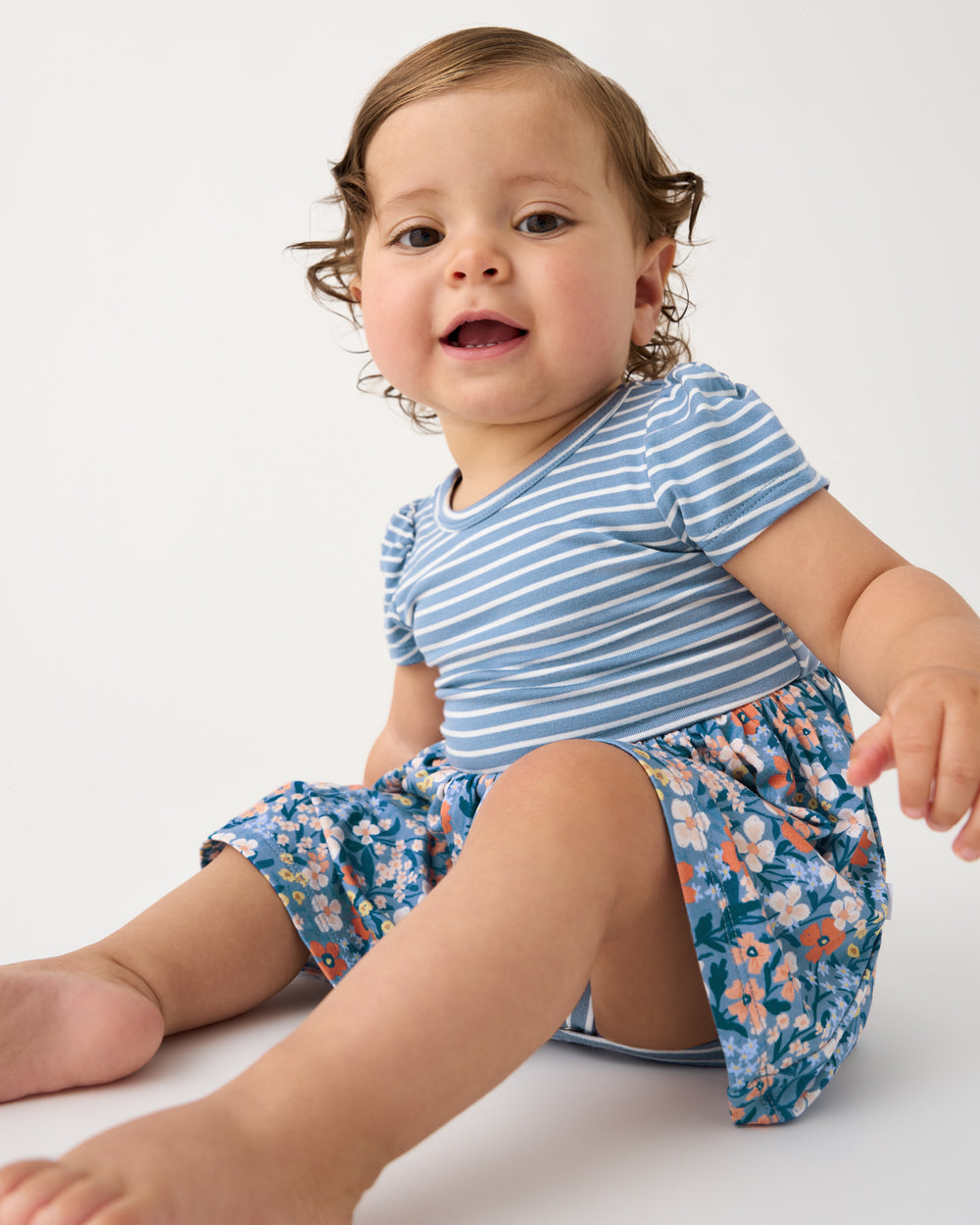 Close up of baby girl wearing the Petite Petals Skater Dress with Bodysuit