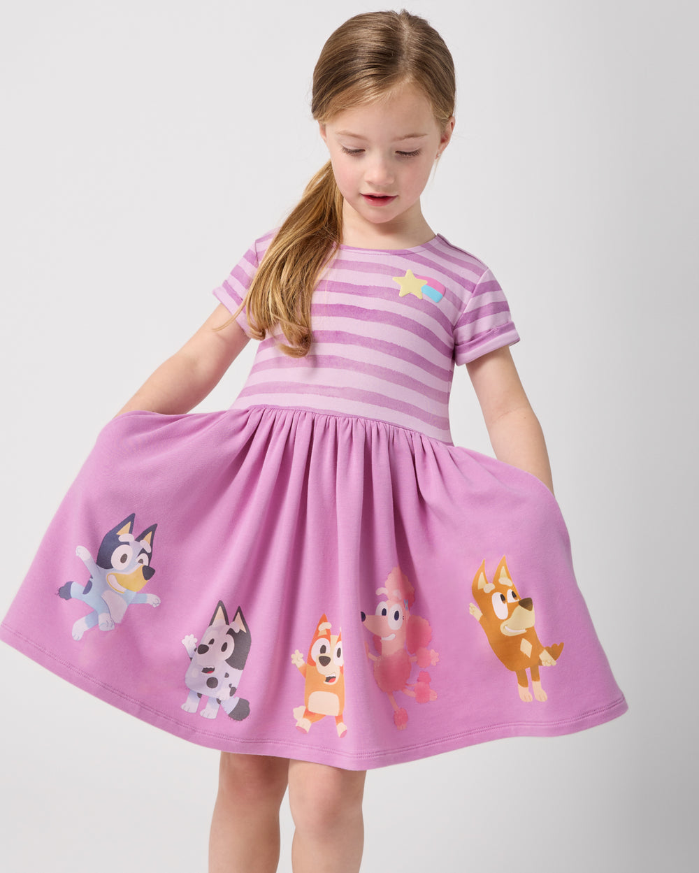 Girl holding out the skirt on the Bluey Friends Forever Pocket Dress