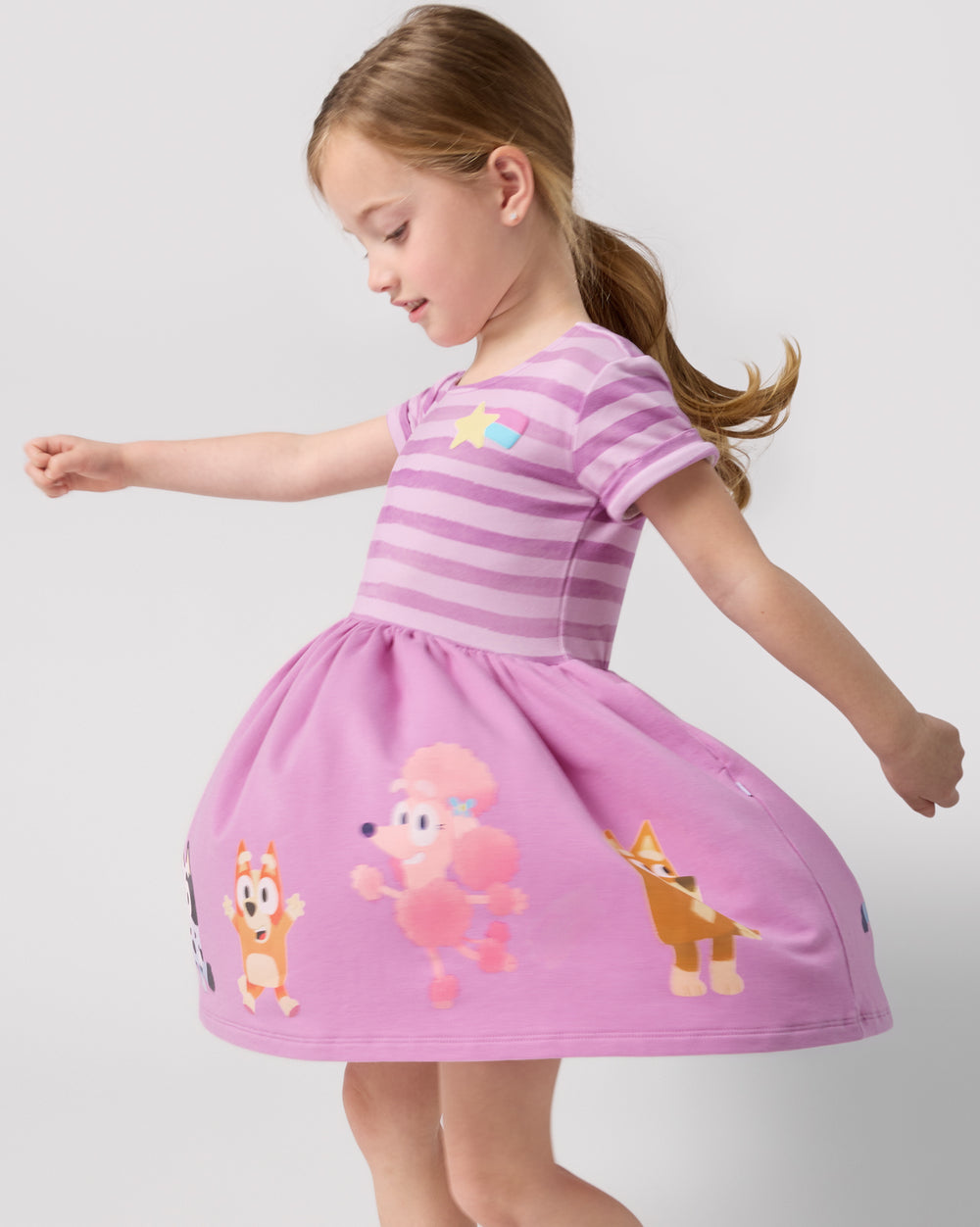 Twirling girl wearing the Bluey Friends Forever Pocket Dress
