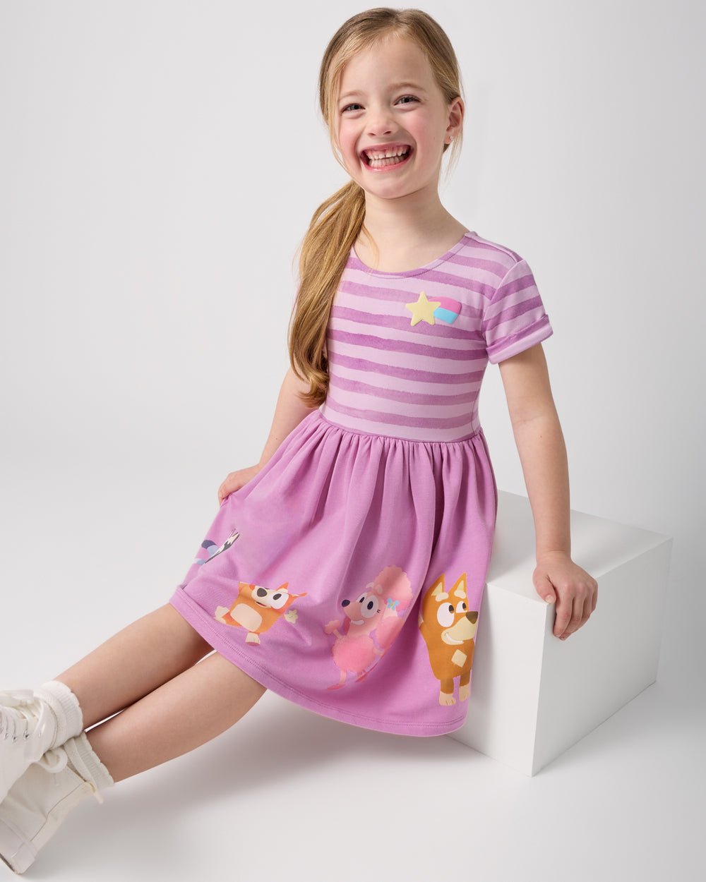 Sitting girl wearing the Bluey Friends Forever Pocket Dress