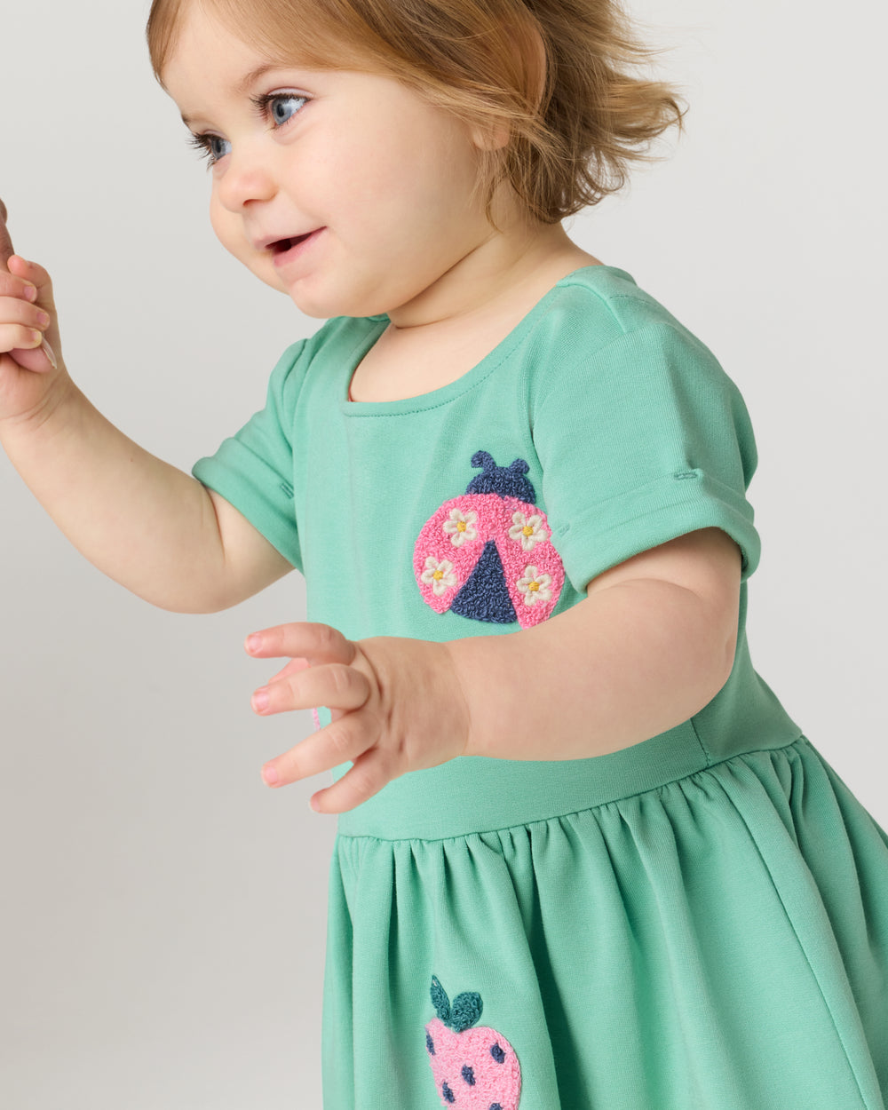 Close up of baby wearing the Garden Party Dress with Bloomer