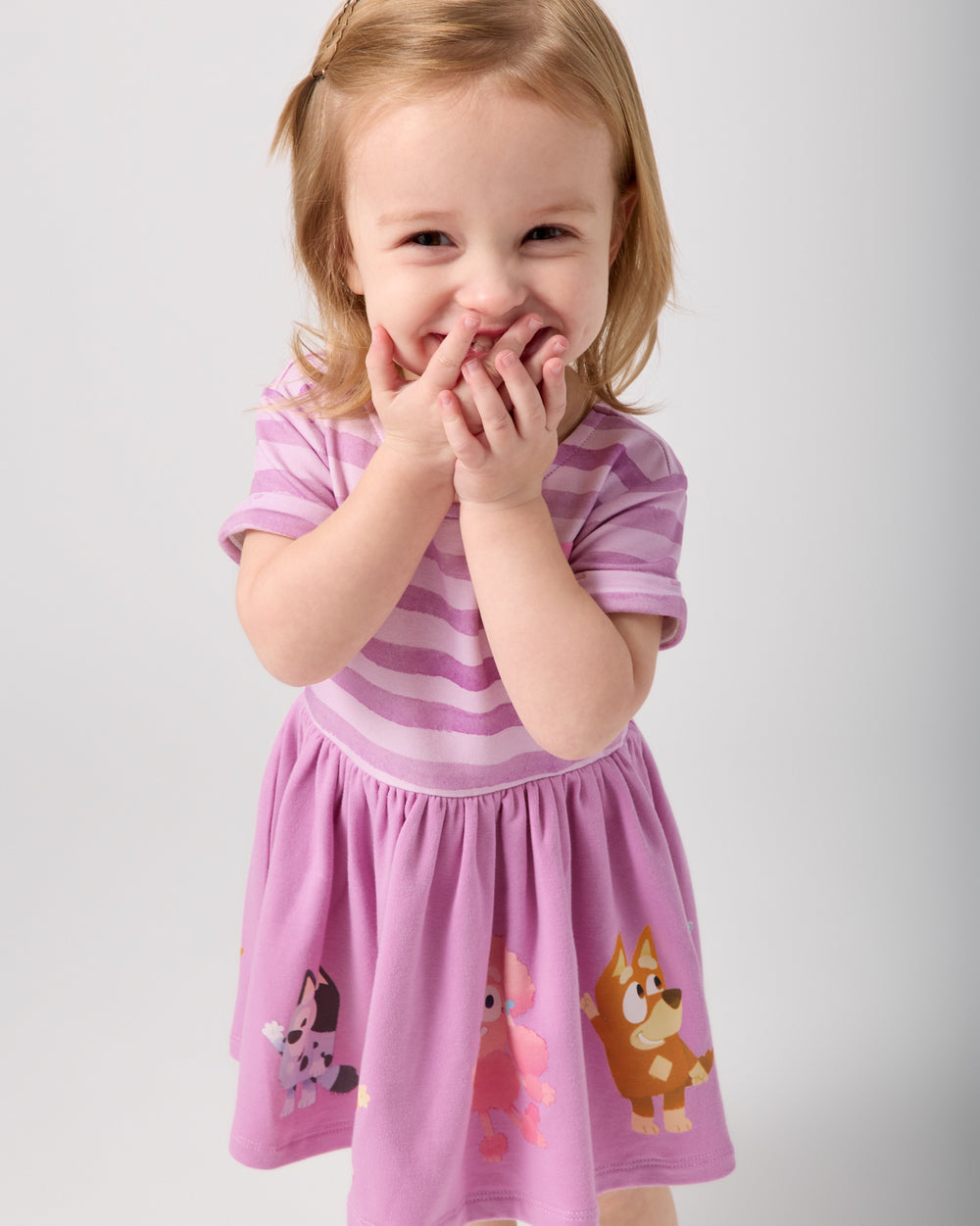 Posing girl wearing the Bluey Friends Forever Dress with Bloomer