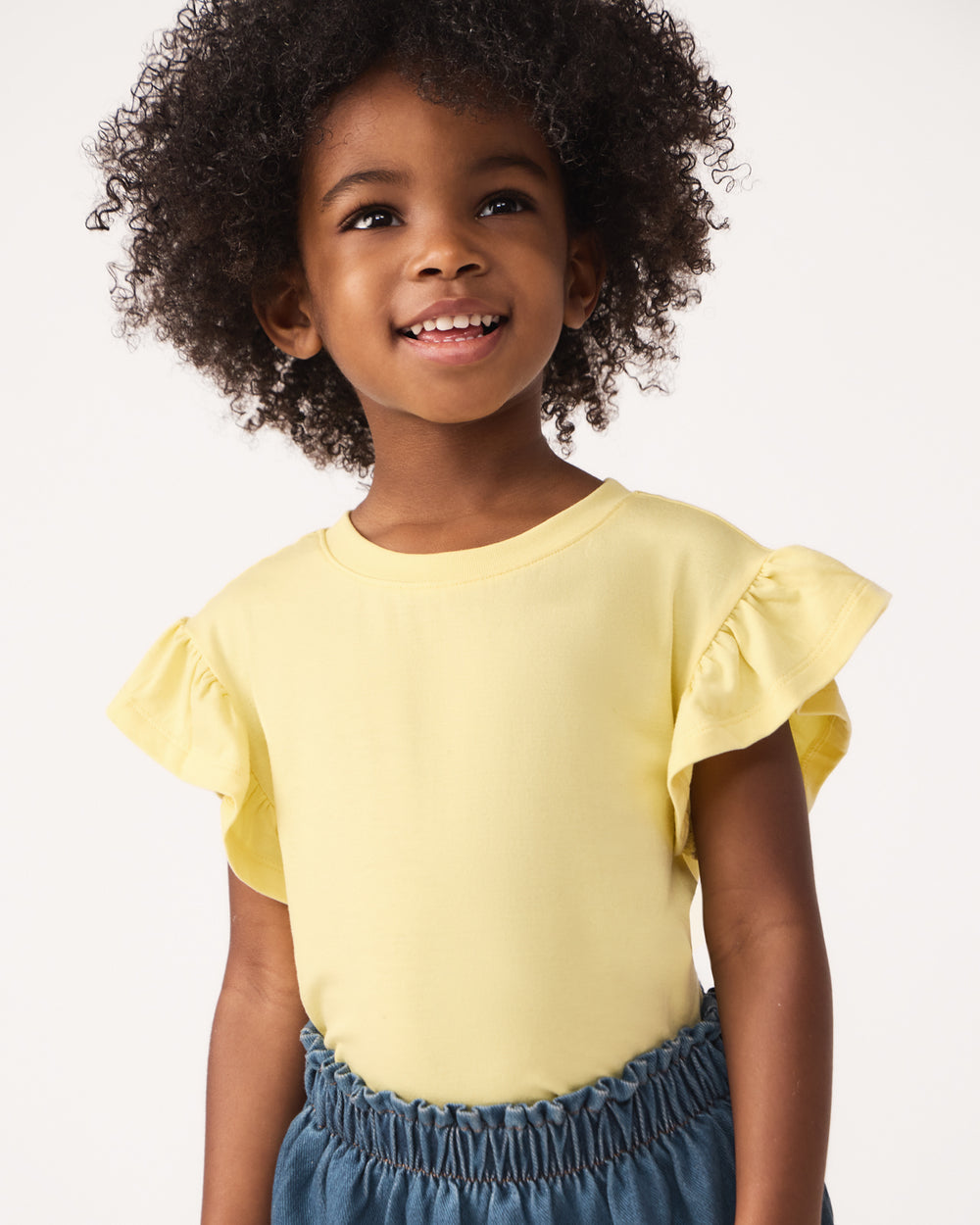 Close up of girt wearing the Lemon Twist Flutter Tee 