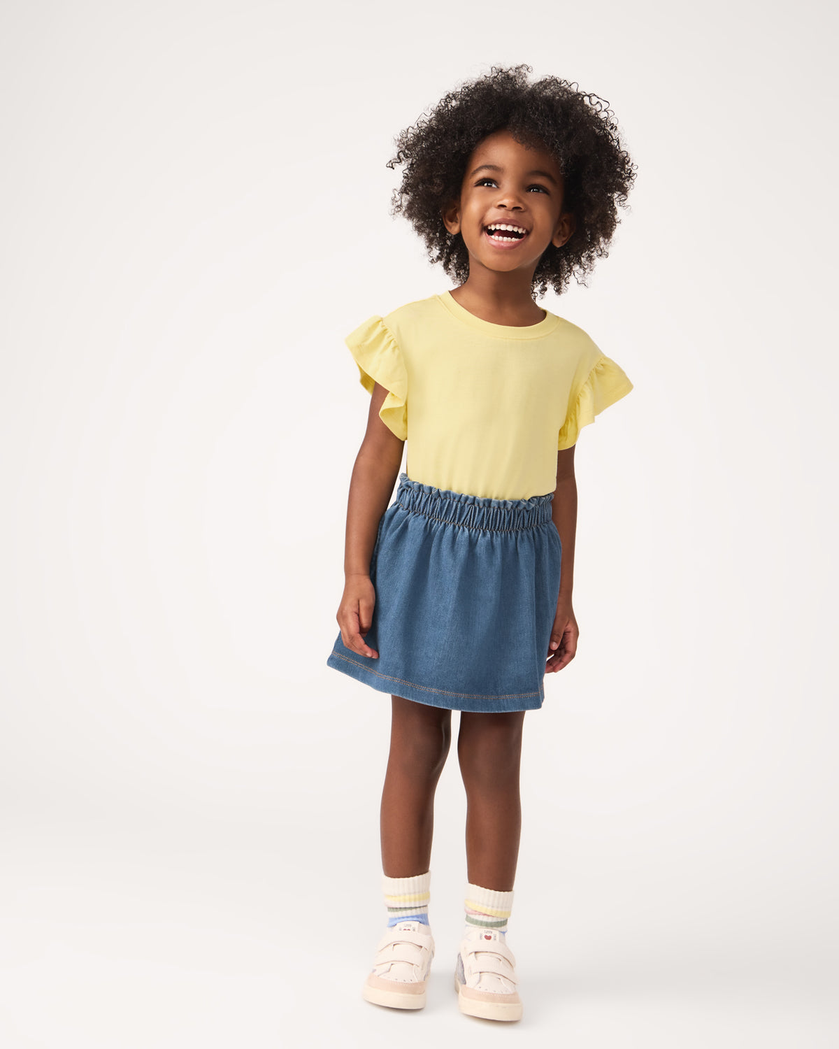 Girl wearing the Midwash Blue Denim Skort with a yellow girls tee