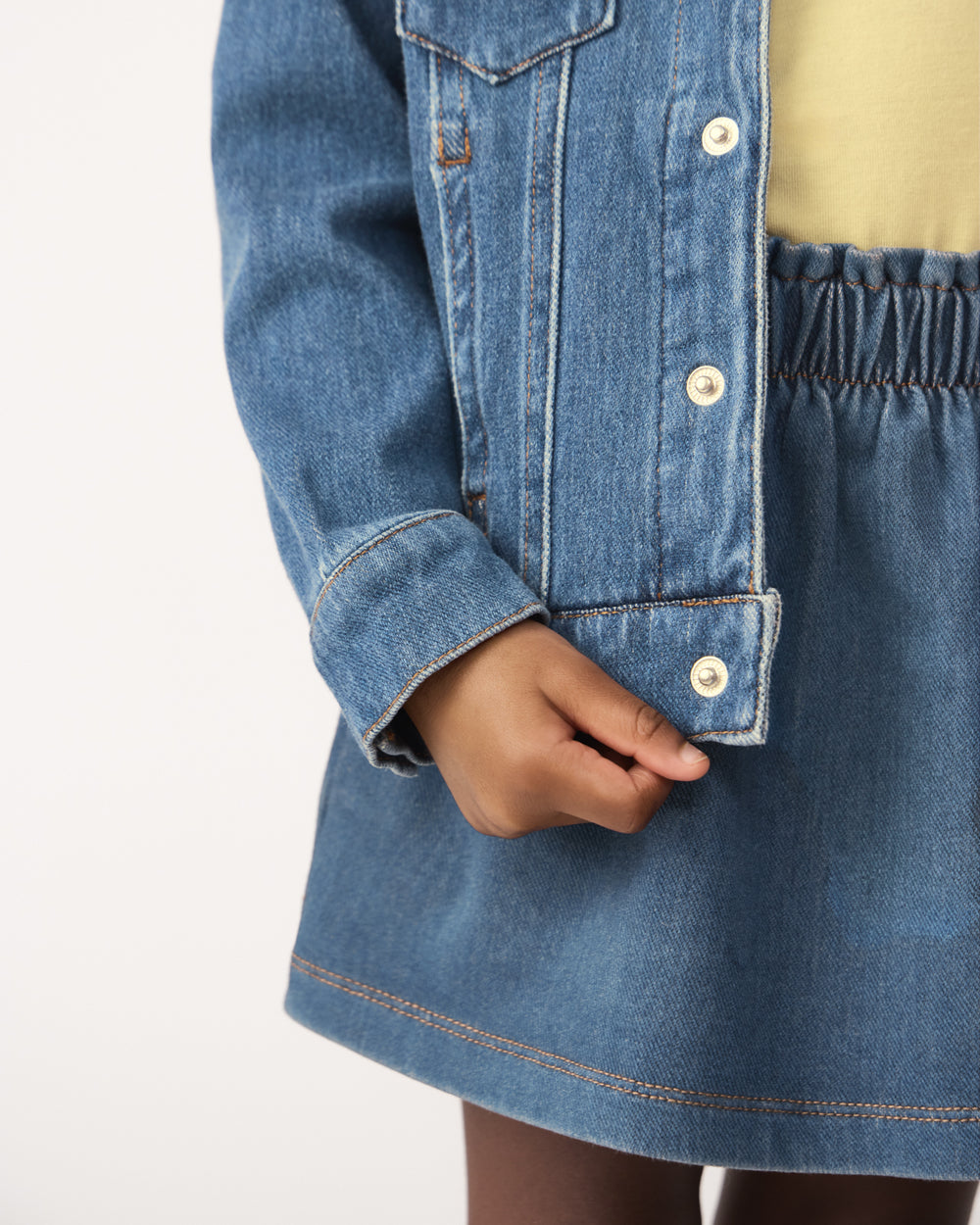 Close up of the button closure on the Midwash Blue Denim Trucker Jacket