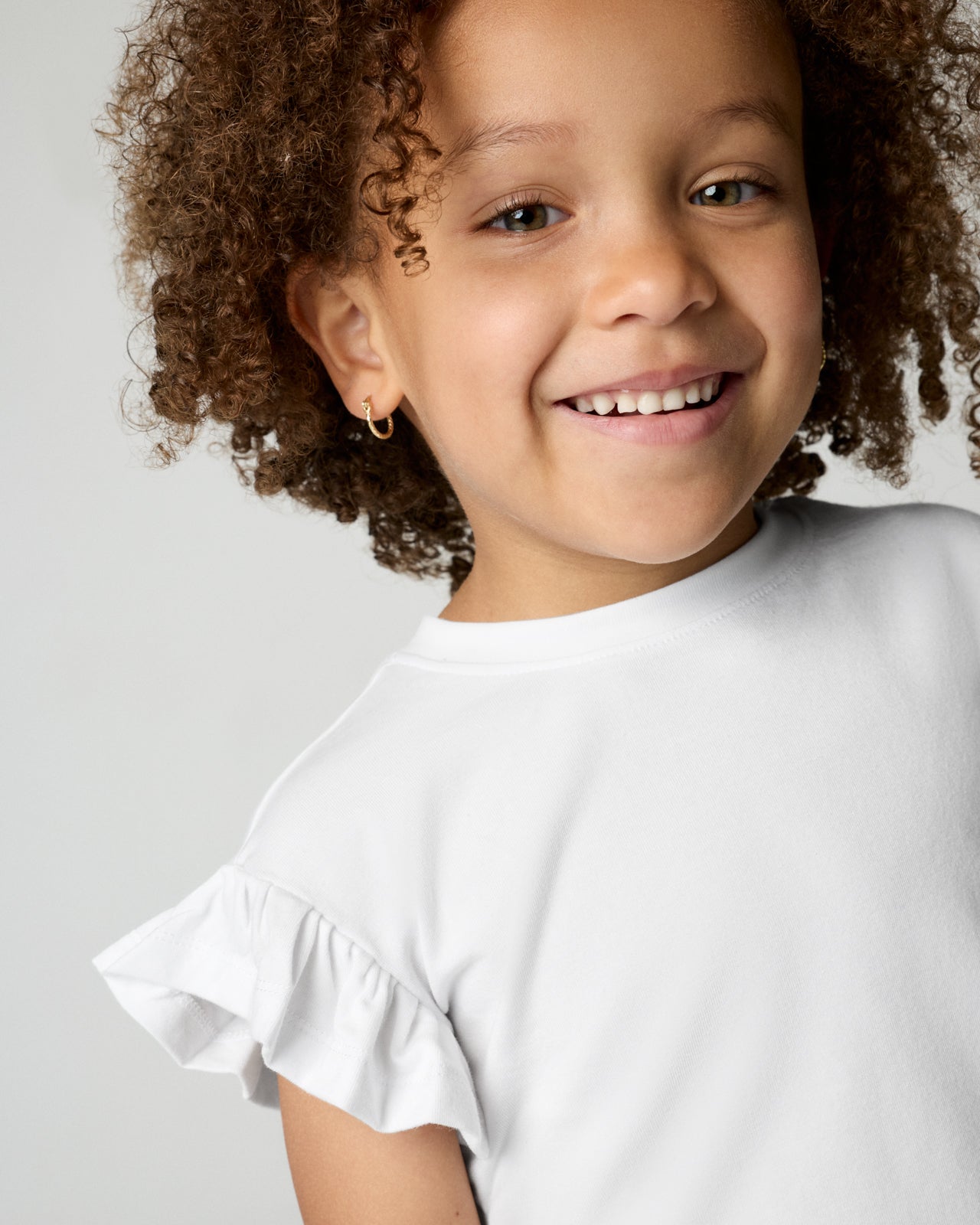 Close up of girl wearing the Bright White Flutter Tee