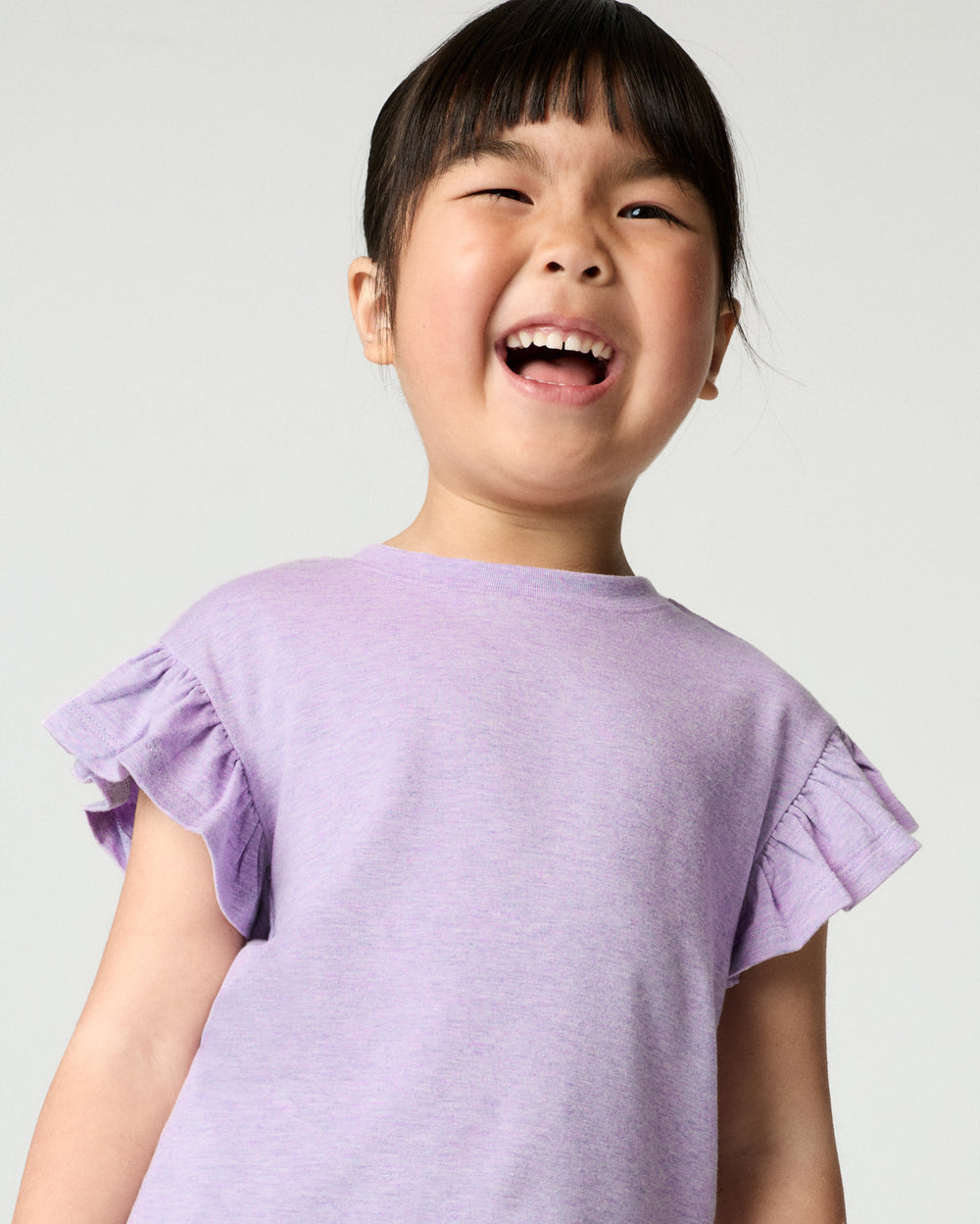 Close up of girl wearing the Heather Lavender Flutter Tee