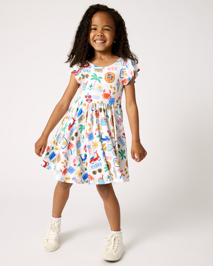 Girl wearing the Ciao Bella Flutter Twirl Dress