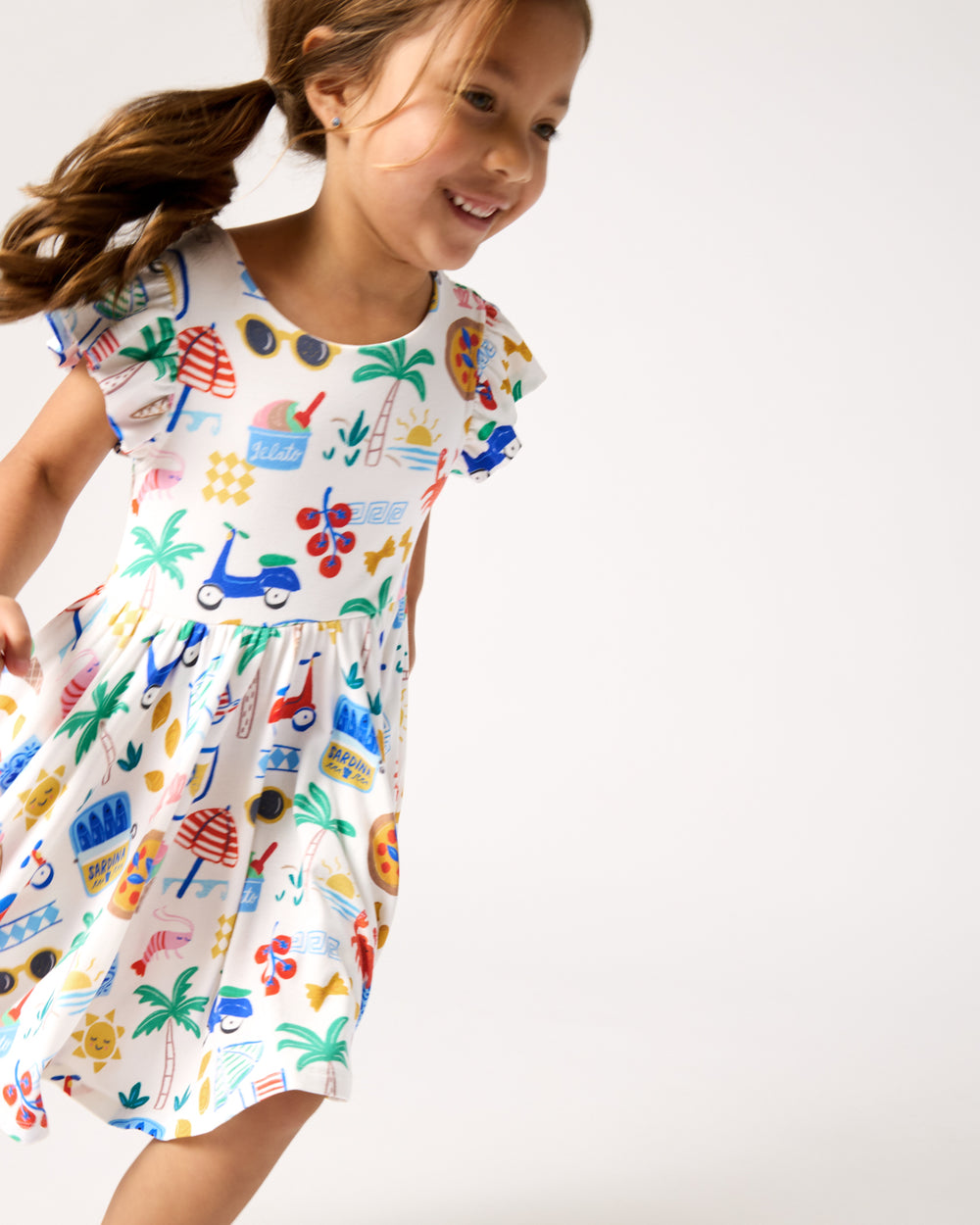 Child in motion wearing the Ciao Bella Flutter Twirl Dress