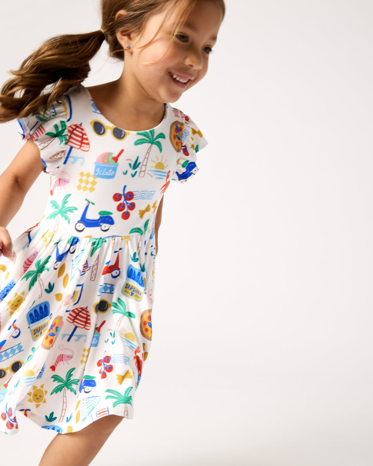 Child in motion wearing the Ciao Bella Flutter Twirl Dress