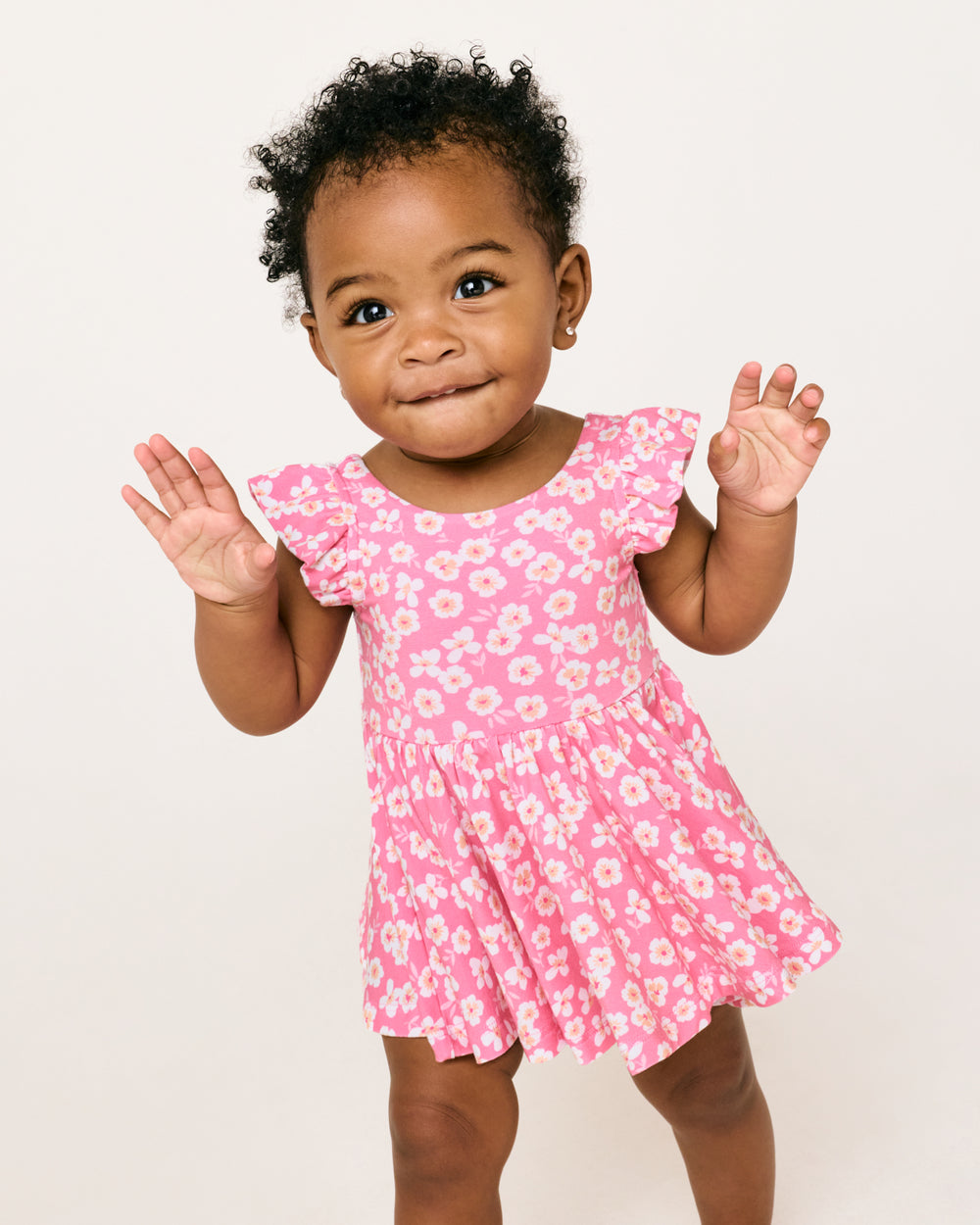 Standing baby wearing the Sweet Pink Petals Flutter Twirl Dress with Bodysuit