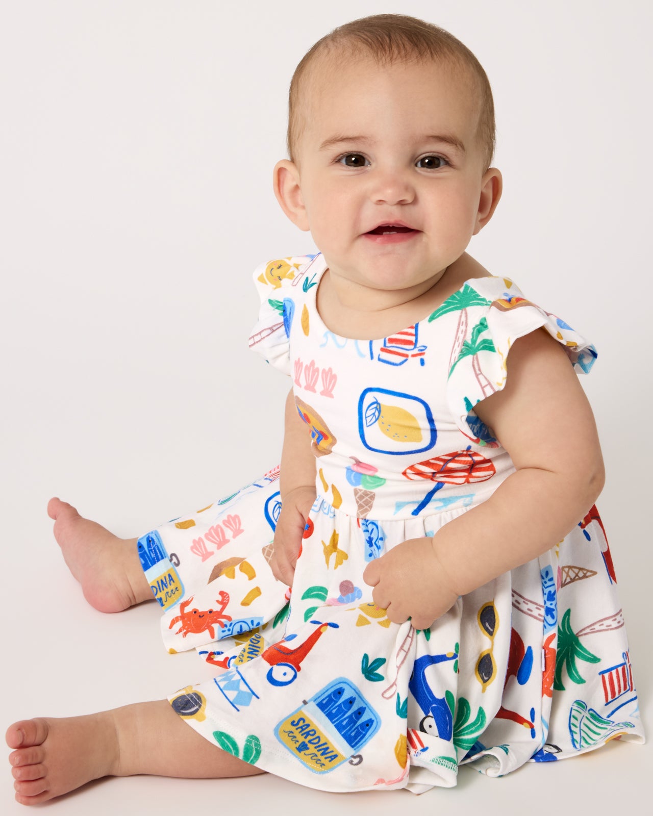 Sitting baby wearing the Ciao Bella Twirl Dress with Bodysuit