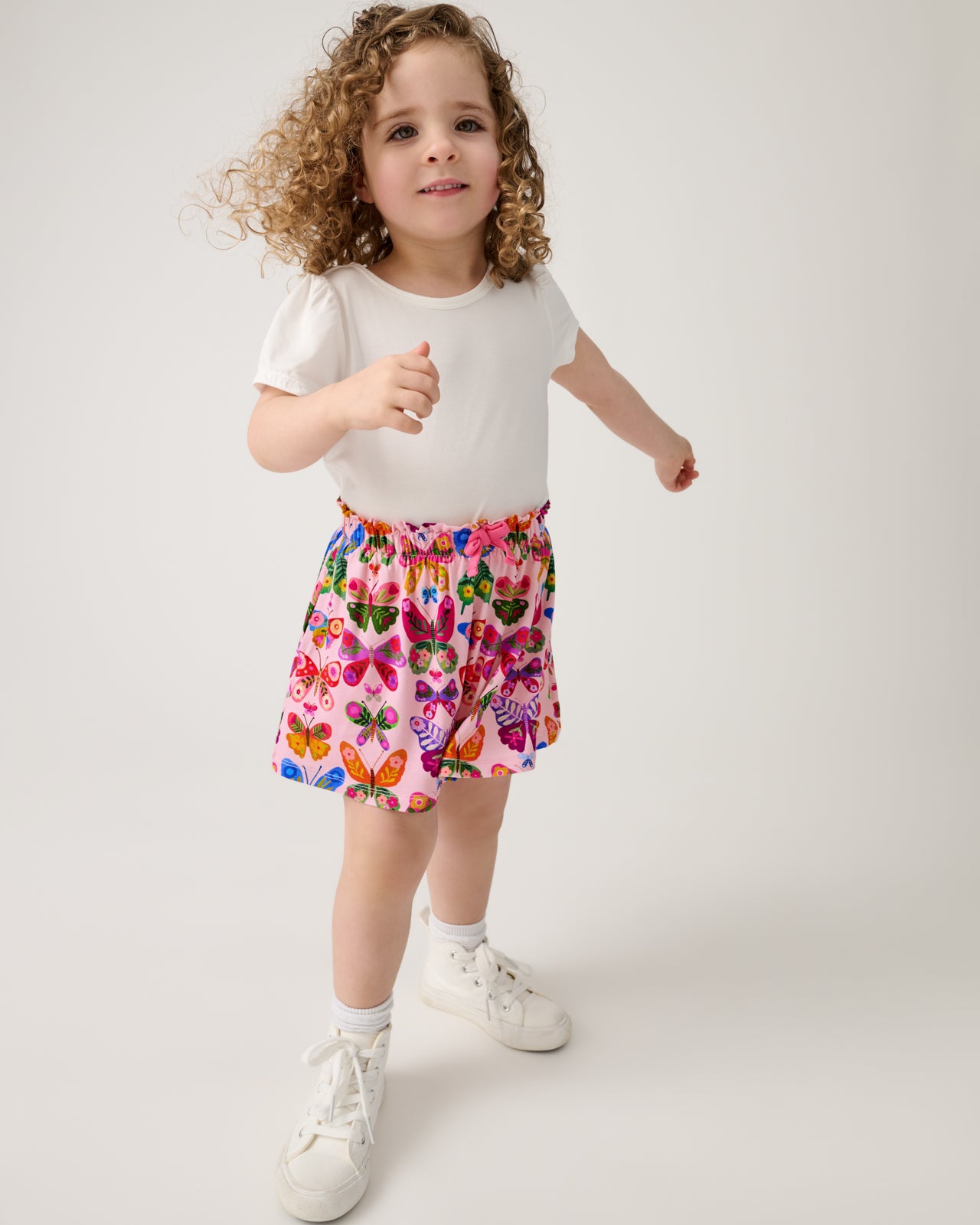 Girl wearing the Flutter Garden Skort with a white tee