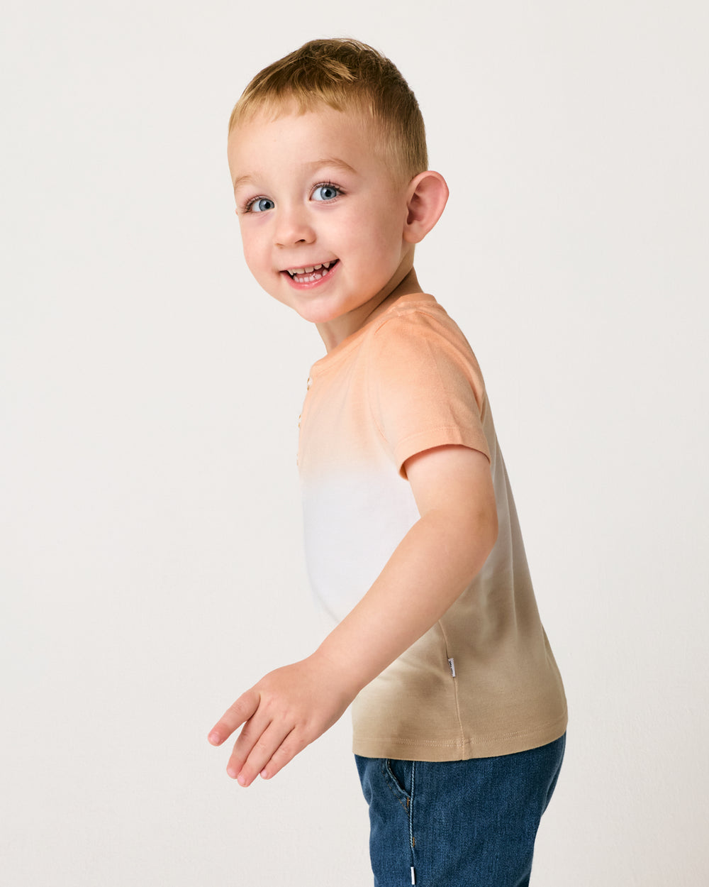 Side view of boy wearing the Golden Hour Henley Tee