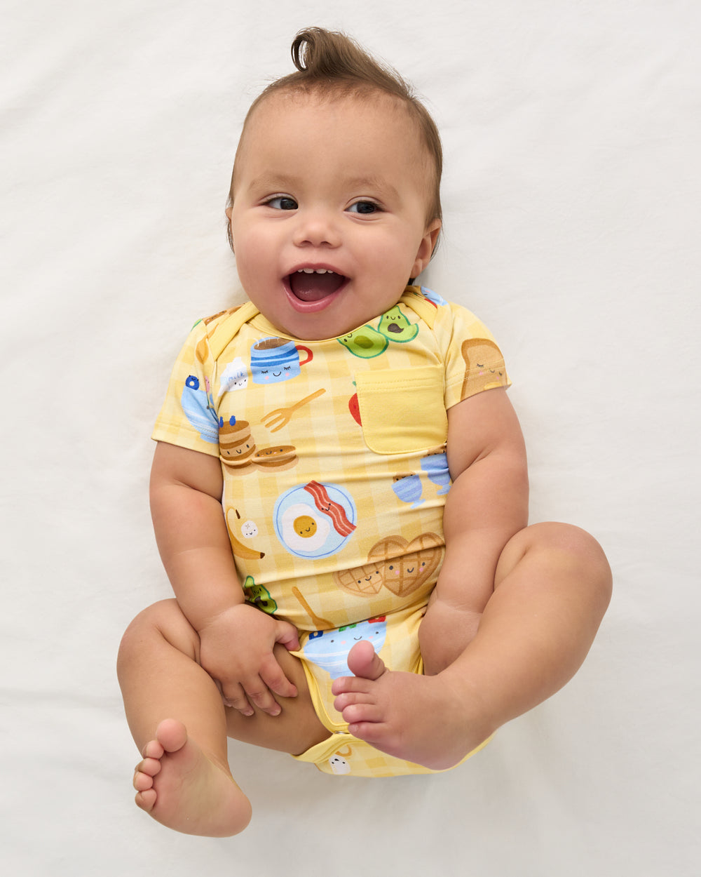 Aerial view of baby wearing the Breakfast Bunch Pocket Bodysuit