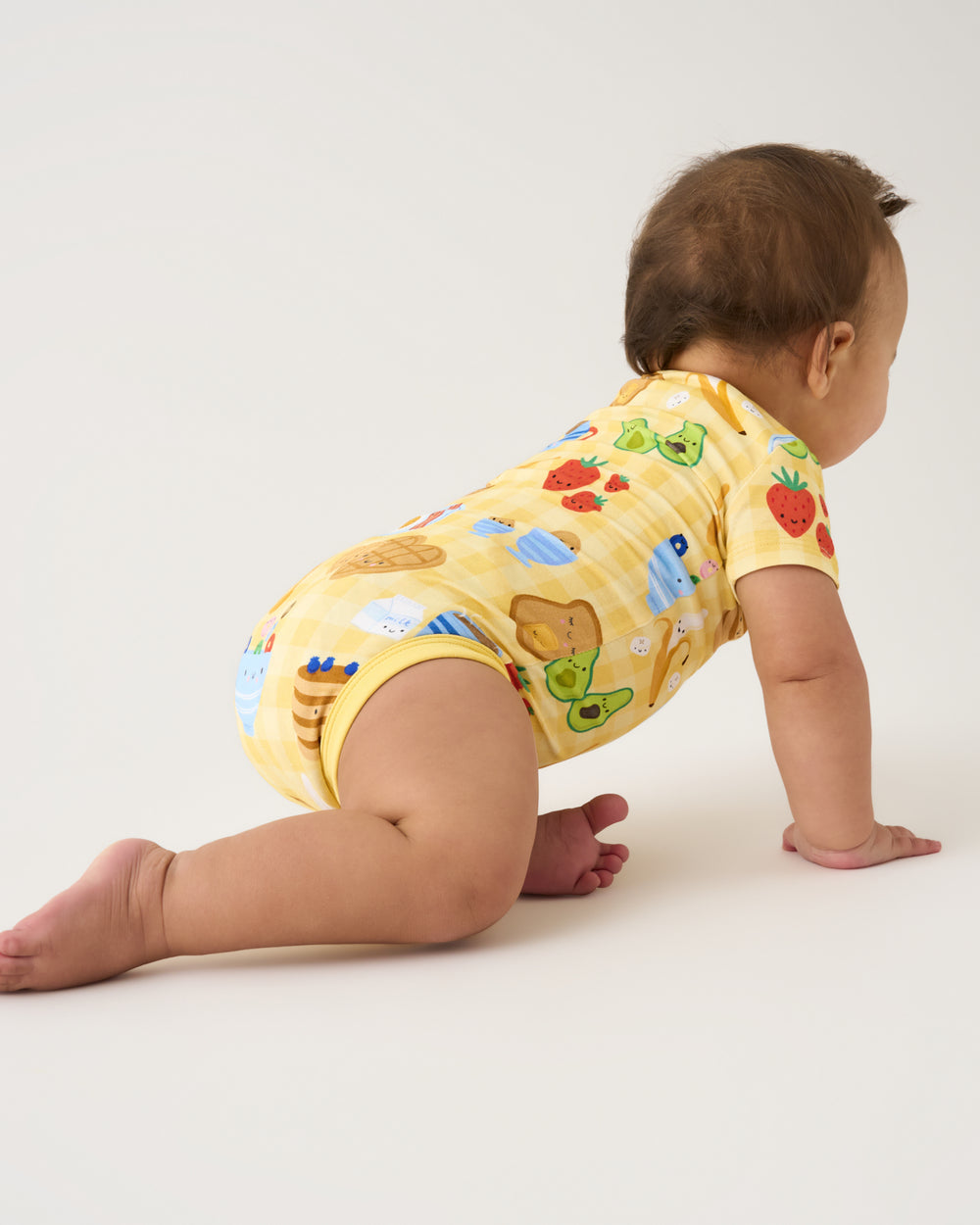 Crawling baby wearing the Breakfast Bunch Pocket Bodysuit