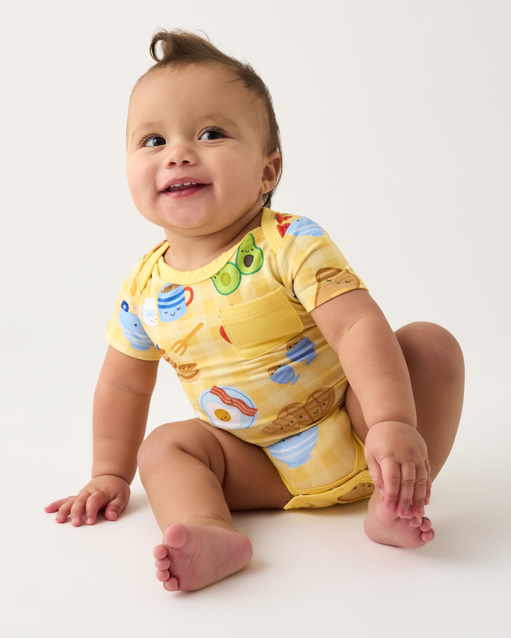 Sitting baby wearing the Breakfast Bunch Pocket Bodysuit