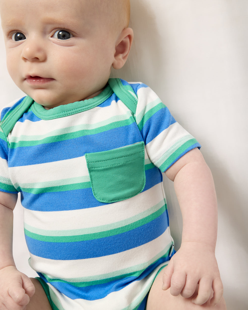 Close up of baby wearing the Blue Bolt Stripes Pocket Bodysuit