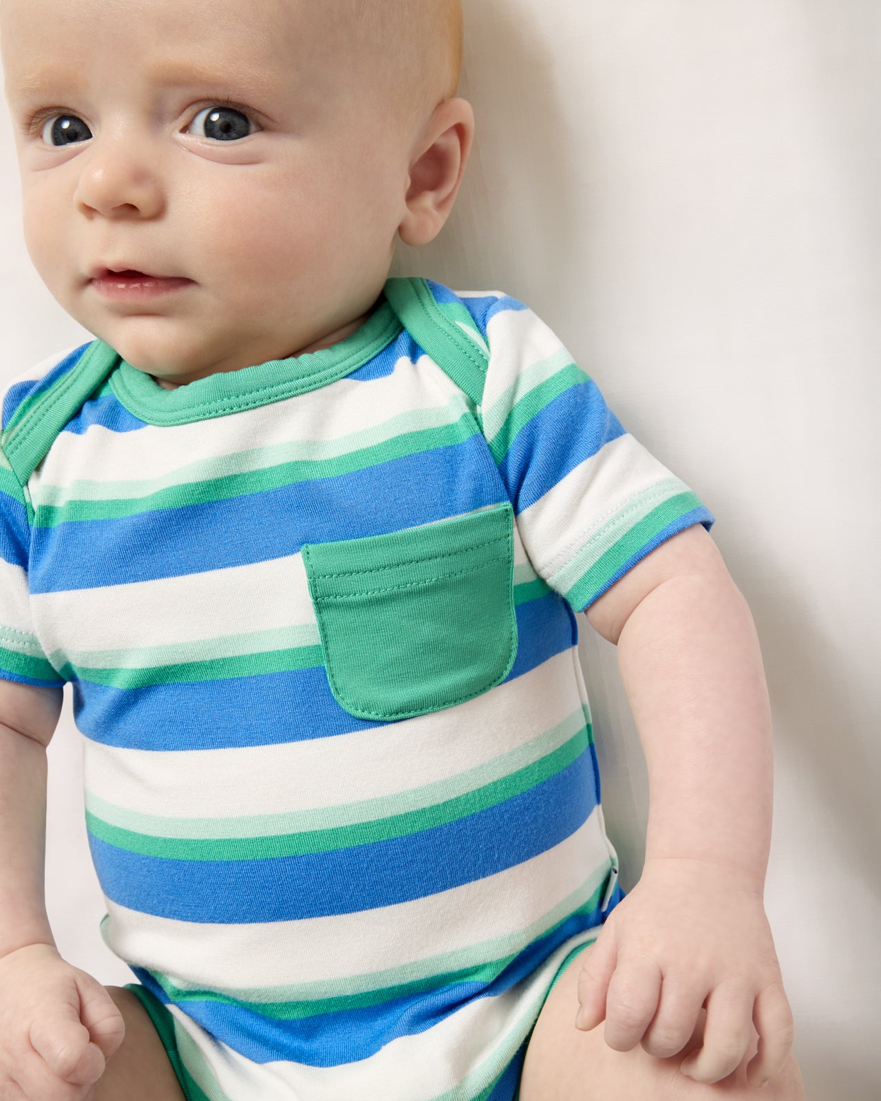Close up of baby wearing the Blue Bolt Stripes Pocket Bodysuit