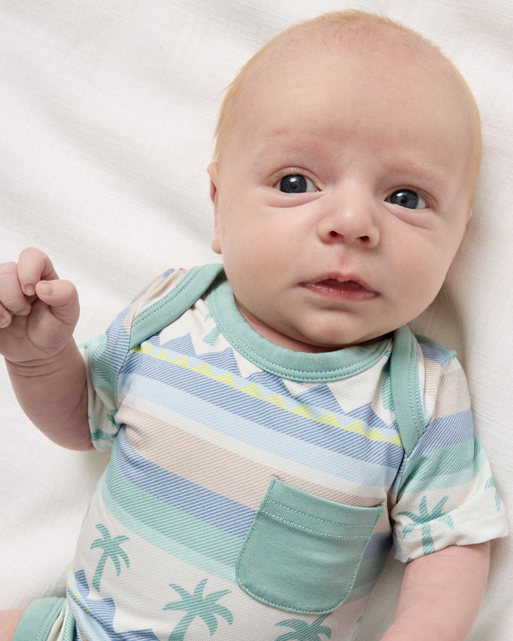 Close up of newborn wearing the Swell Stripes Pocket Bodysuit