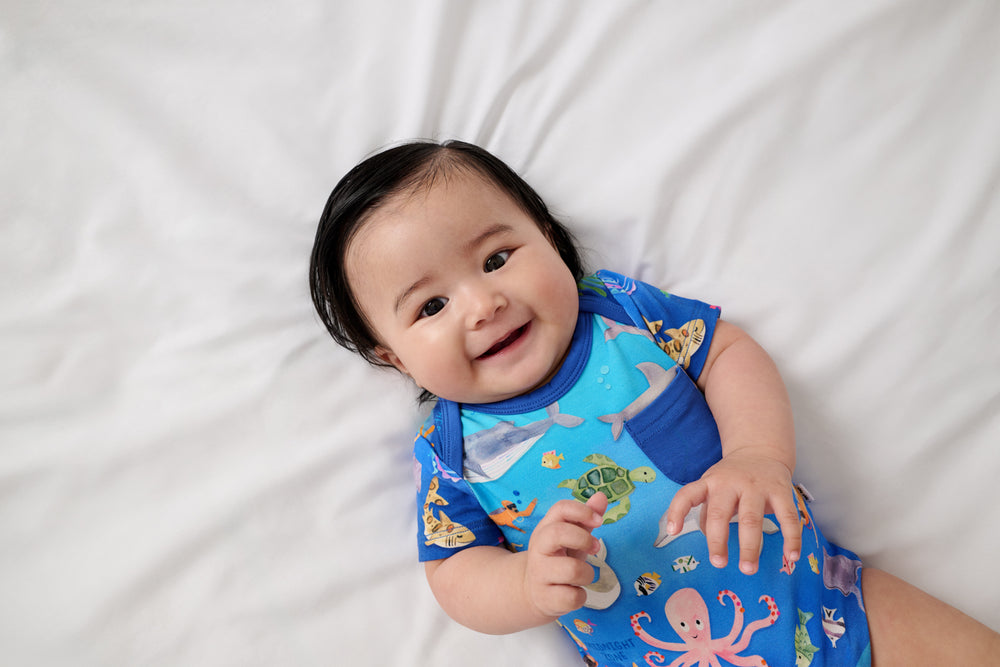 Close up of baby wearing the Underwater Discovery Pocket Bodysuit