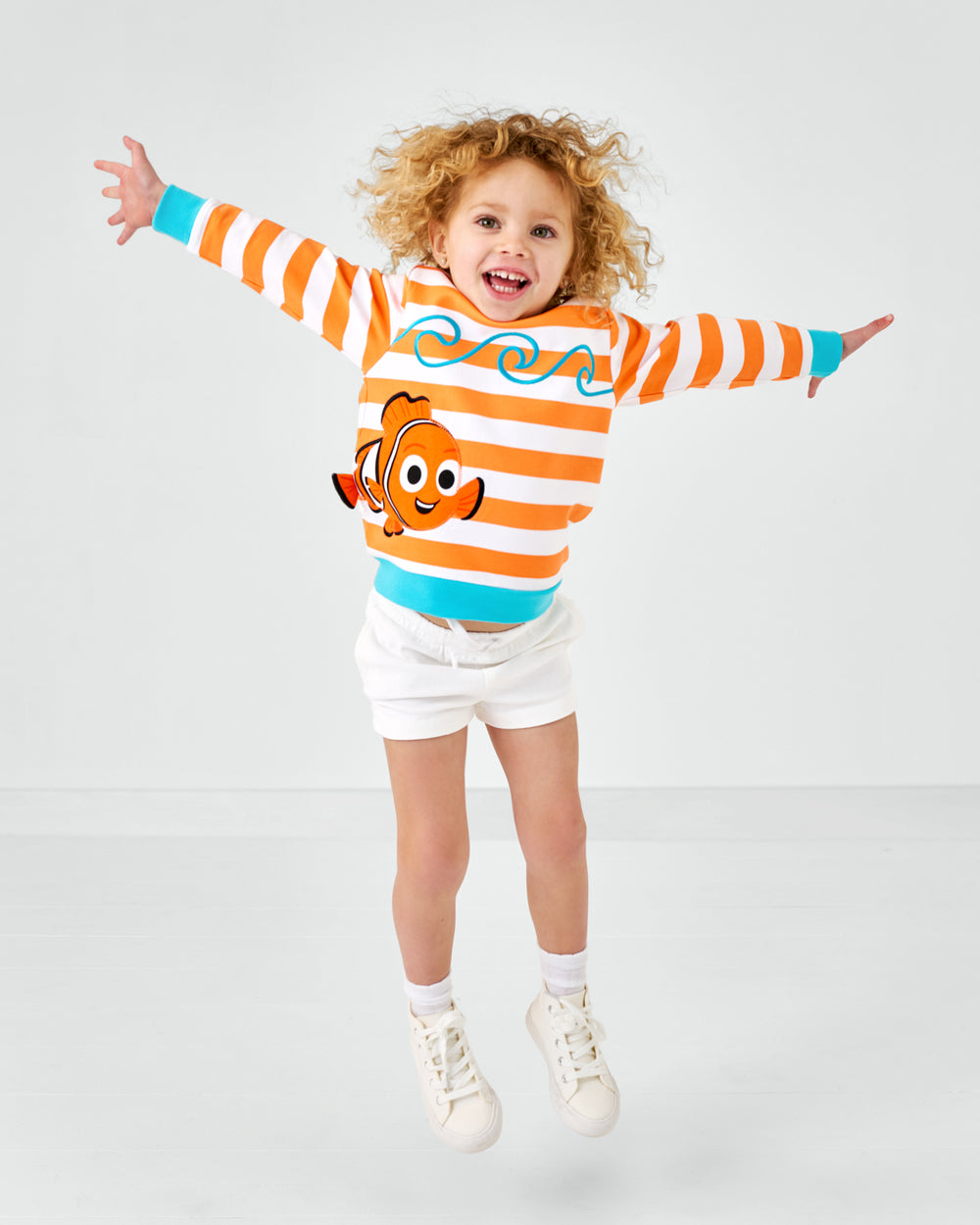 Jumping child wearing the Disney Nemo Crewneck Sweatshirt