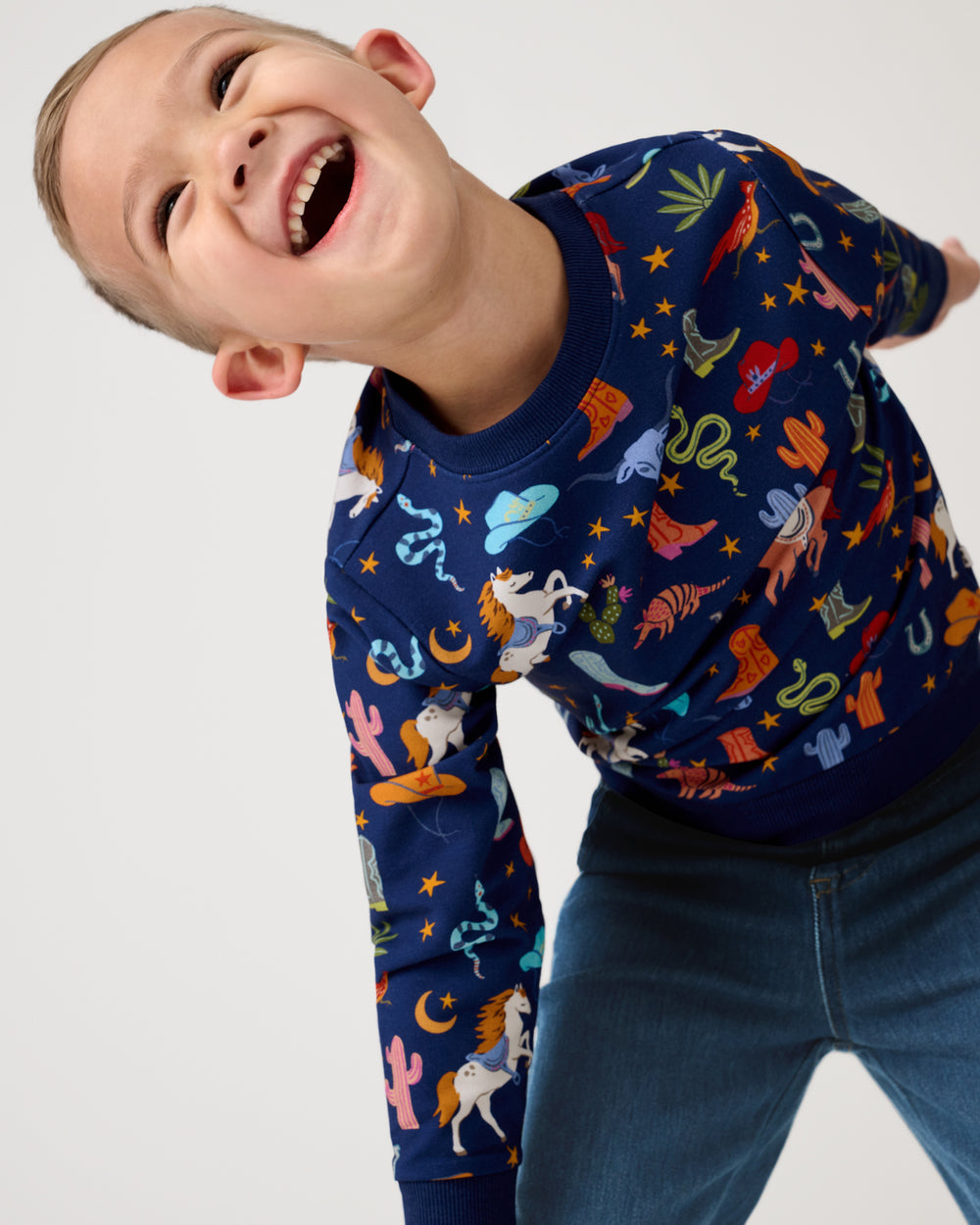Boy wearing the Blue Rancher Roundup Crewneck Sweatshirt with denim pants