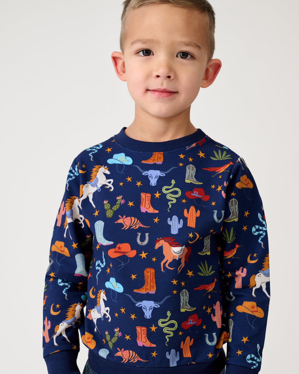 Close up of boy wearing the Blue Rancher Roundup Crewneck Sweatshirt