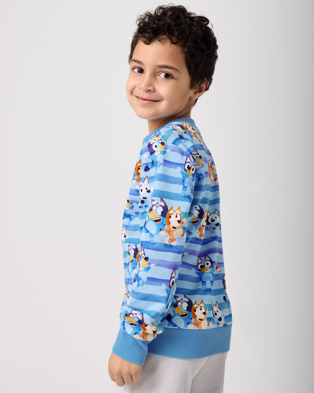 Side view of boy wearing the Bluey Dance All Day Crewneck Sweatshirt