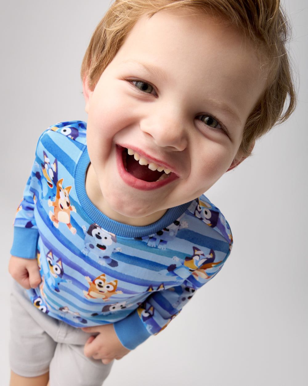 Close up of boy wearing the Bluey Dance All Day Crewneck Sweatshirt