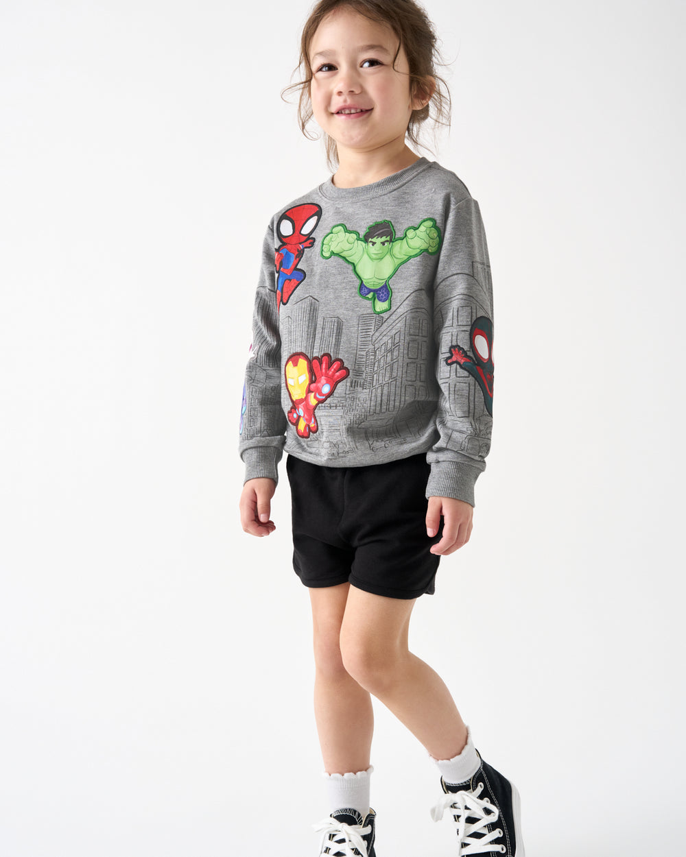Girl wearing the Spidey & Friends Mighty City Heroes Crewneck Sweatshirt with black shorts