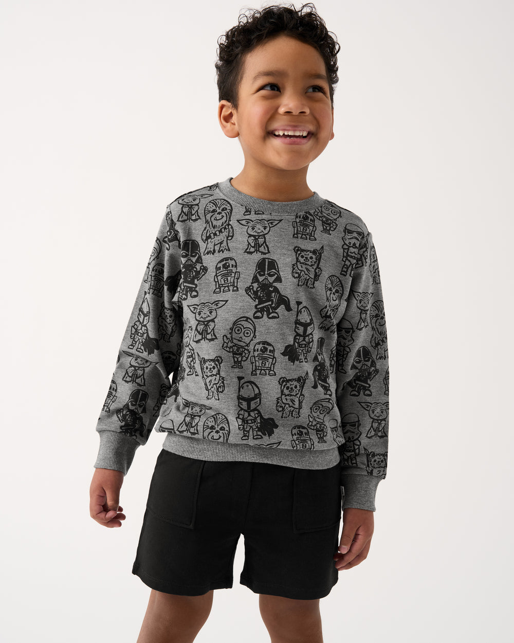Boy wearing the Star Wars Far, Far, Away Friends Crewneck Sweatshirt and Black Shorts