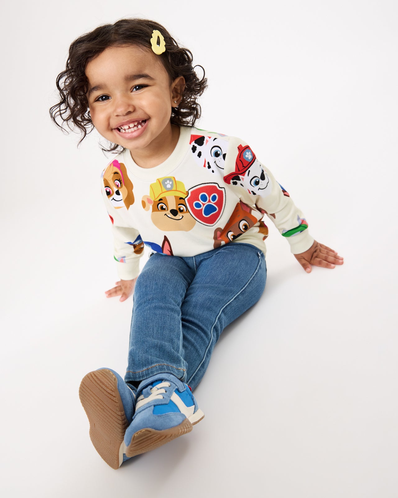 Girl wearing the PAW Patrol Rescue Ready Crewneck Sweatshirt with denim pants