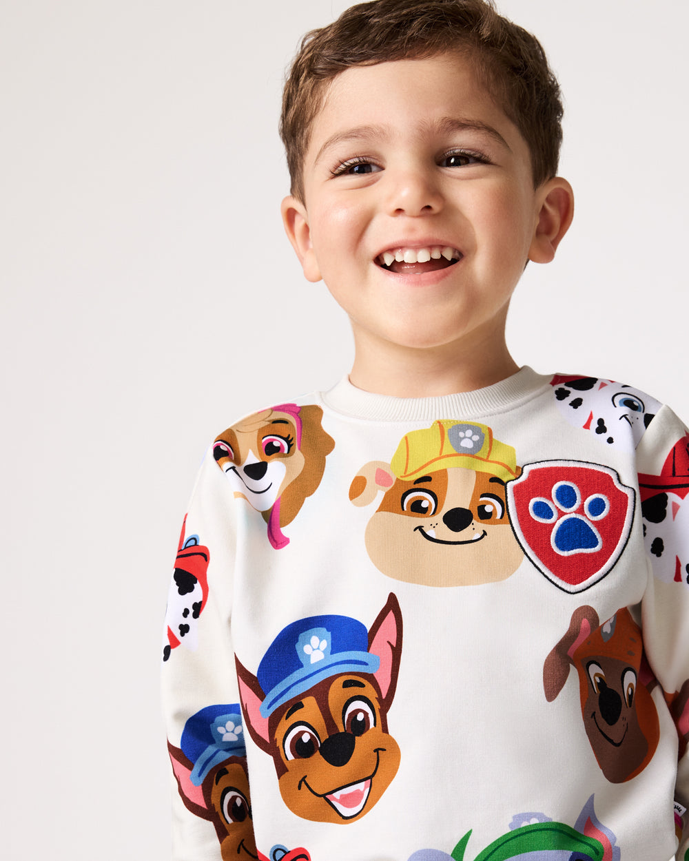 Boy wearing the PAW Patrol Rescue Ready Crewneck Sweatshirt with denim joggers