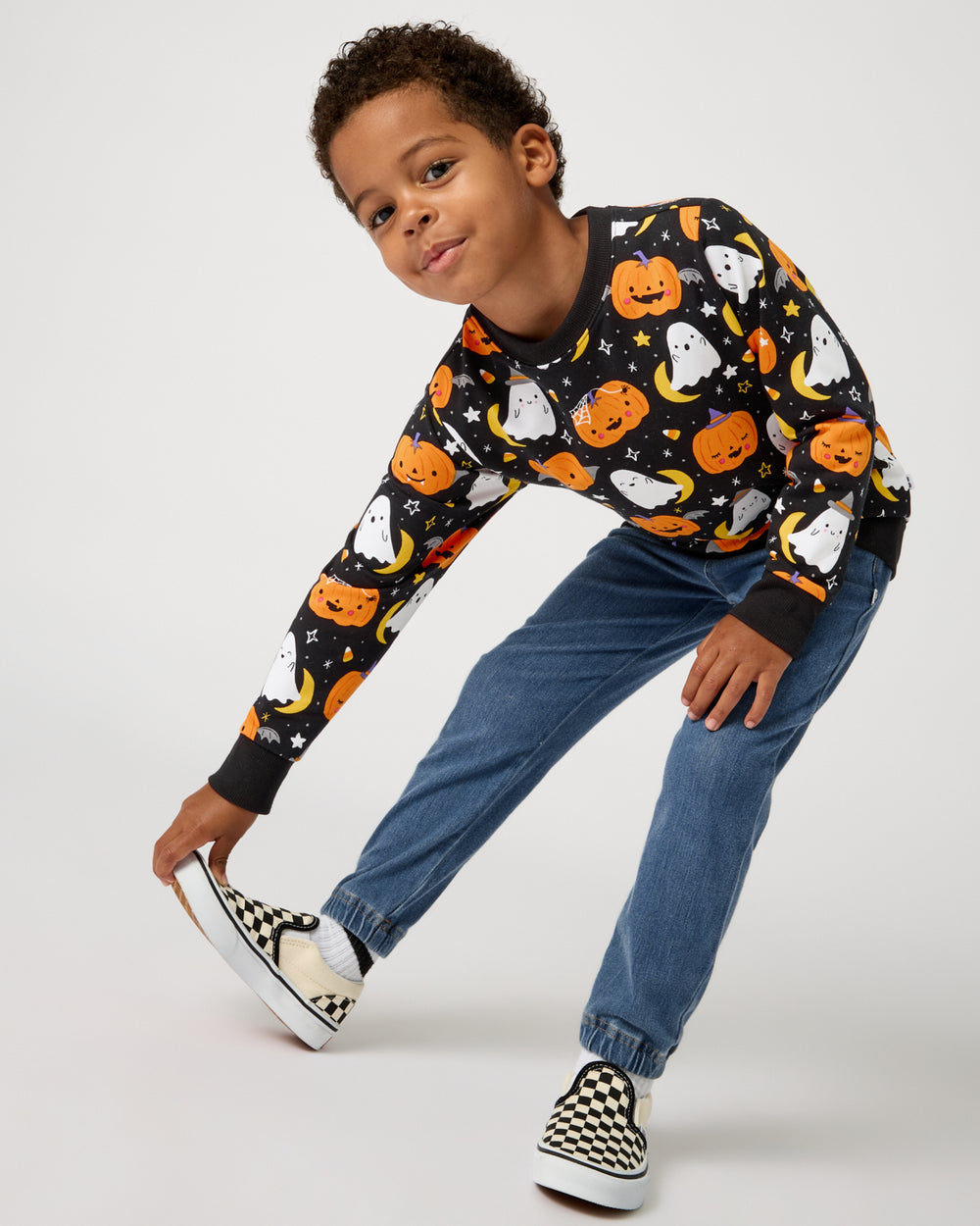 Boy wearing the Moonlit Magic Crewneck Sweatshirt with checkered shoes