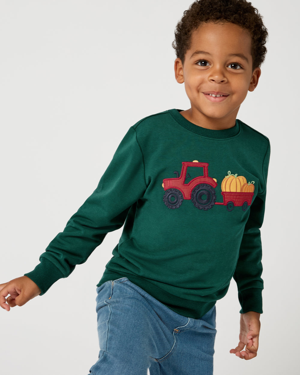 Boy wearing the Tractor Ride Crewneck Sweatshirt with denim pants