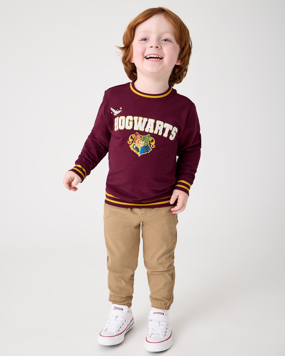 Boy wearing the Harry Potter™ Spellbinding Studies Crewneck Sweatshirt with khaki joggers