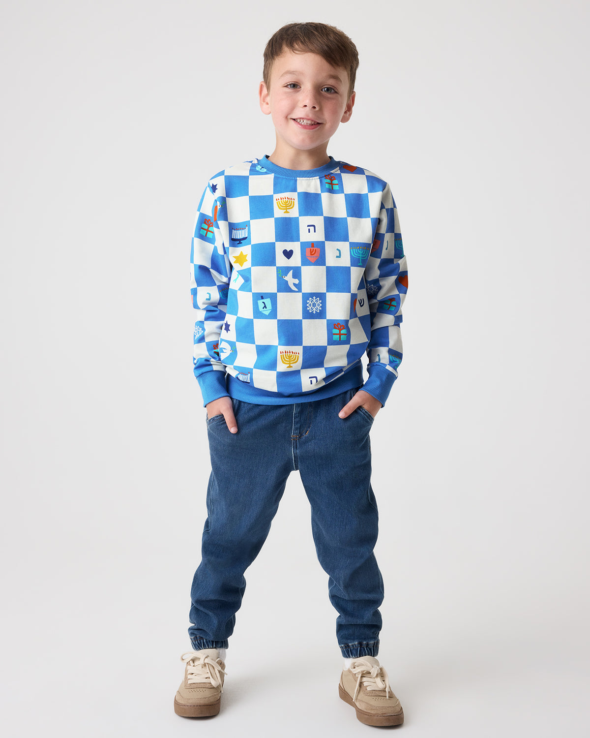 Boy wearing the Hanukkah Checks Crewneck Sweatshirt with denim joggers