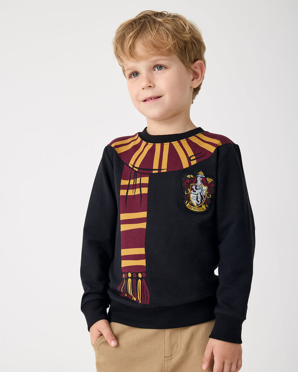 Close up of boy wearing the Harry Potter™ Gryffindor Crewneck Sweatshirt