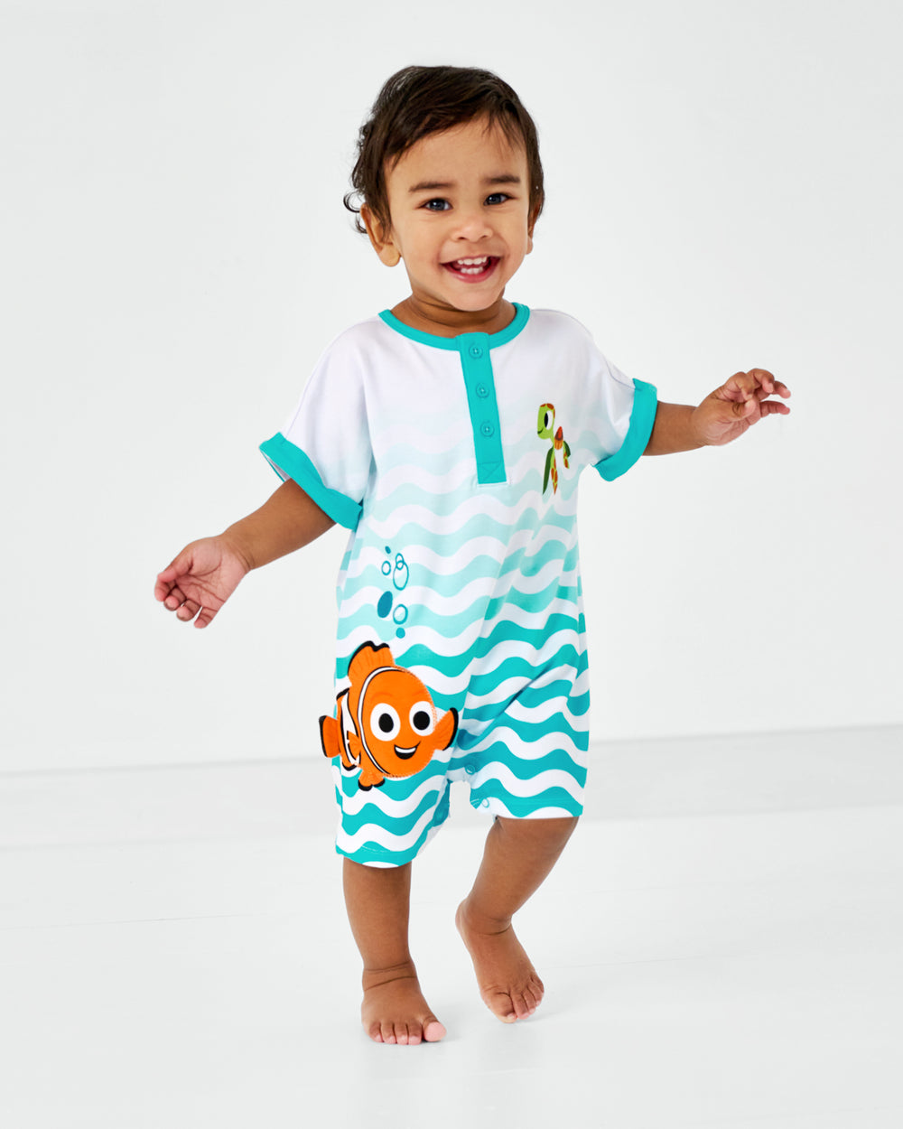 Alternate walking toddler wearing the Pixar Nemo Dolman Henley Romper