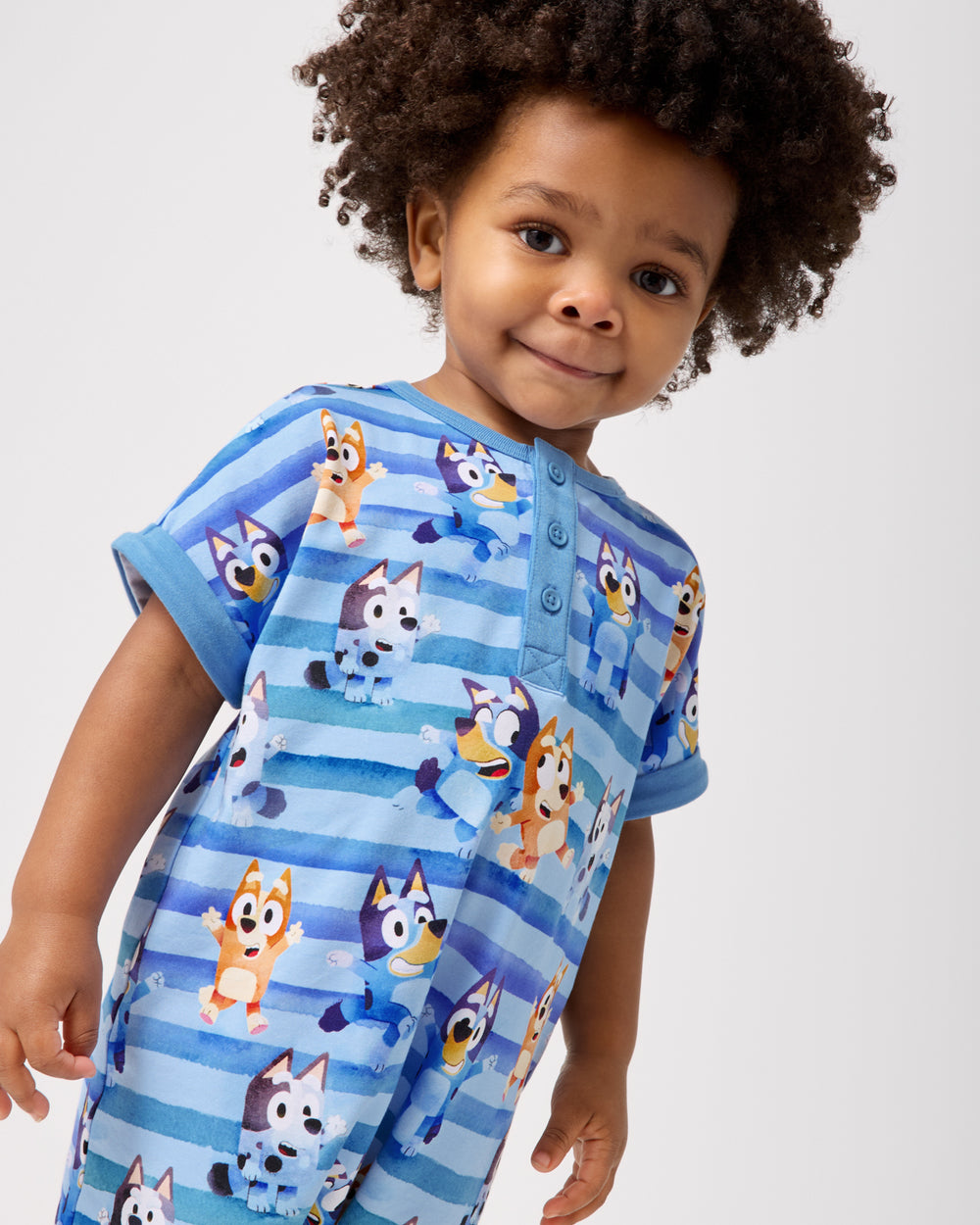 Close up of boy wearing the Bluey Dance All Day Dolman Henley Romper