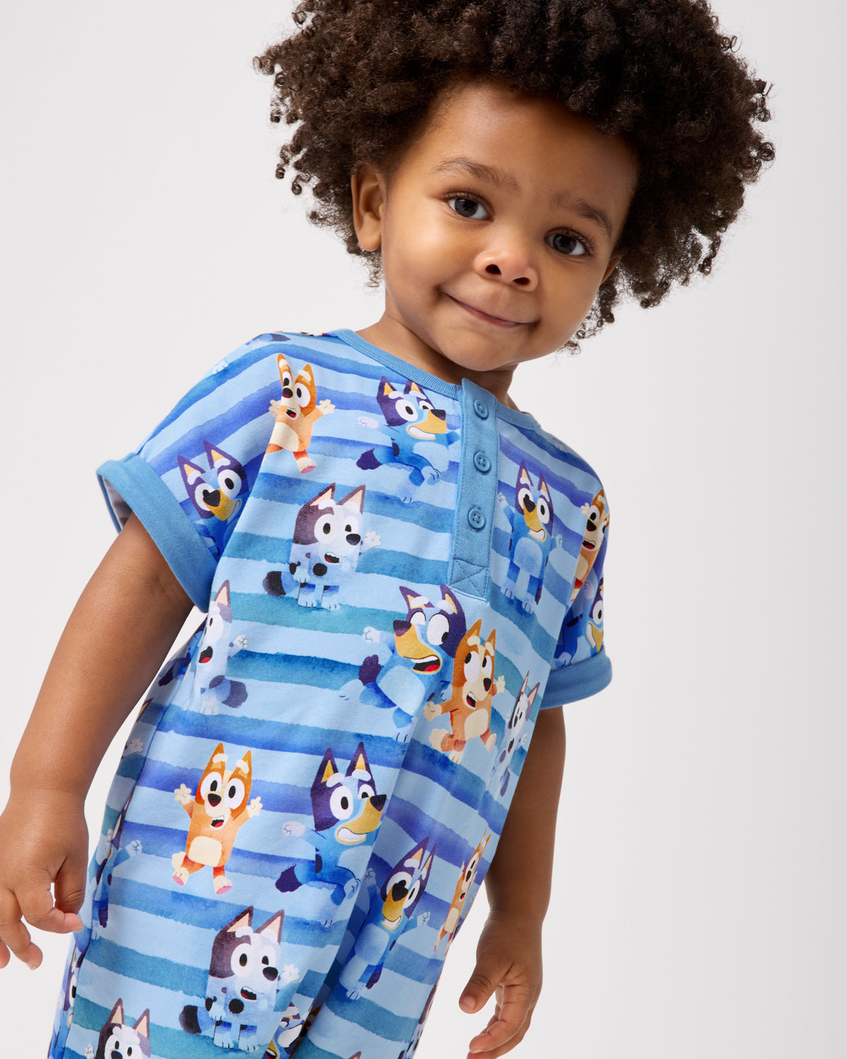 Close up of boy wearing the Bluey Dance All Day Dolman Henley Romper
