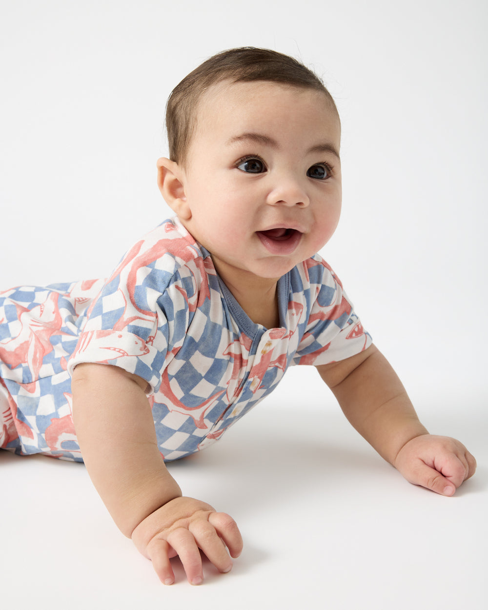 Crawling baby wearing the Shark Fin Checks Dolman Henley Romper