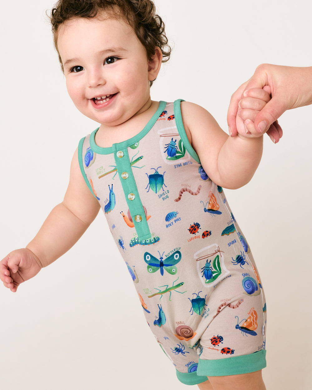 Walking toddler wearing the Nature Notes Henley Romper
