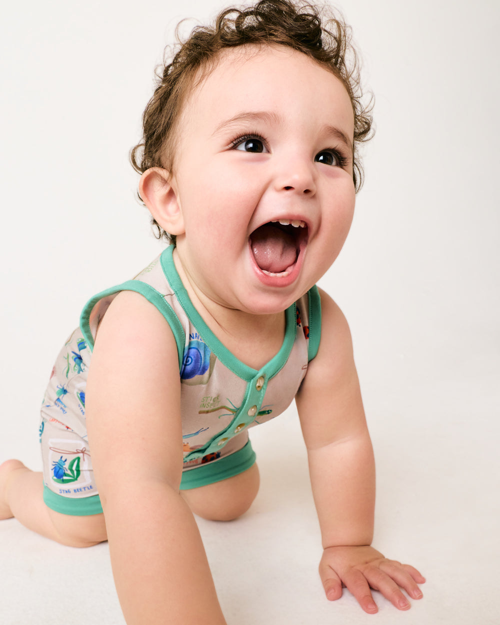 Crawling baby wearing the Nature Notes Henley Romper