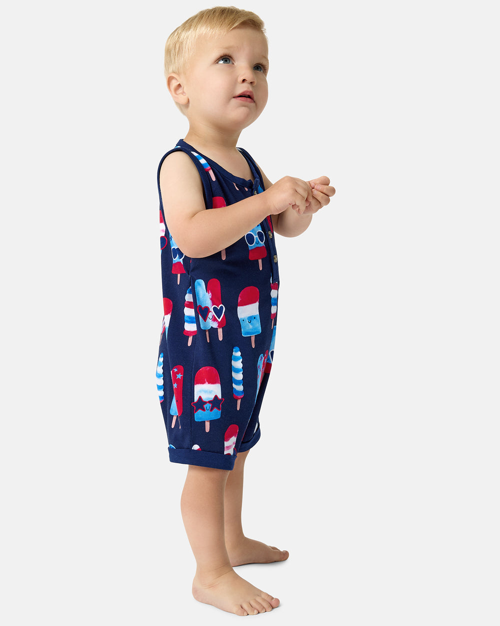 Standing child wearing the Sparkle Treats Henley Romper