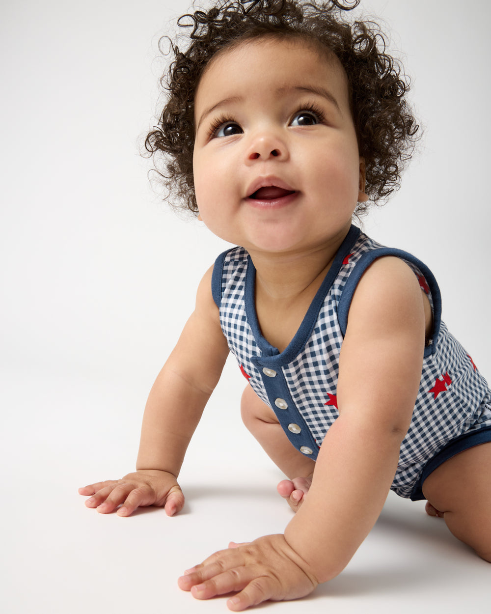 Crawling baby wearing the Blue Ribbon Gingham Henley Romper