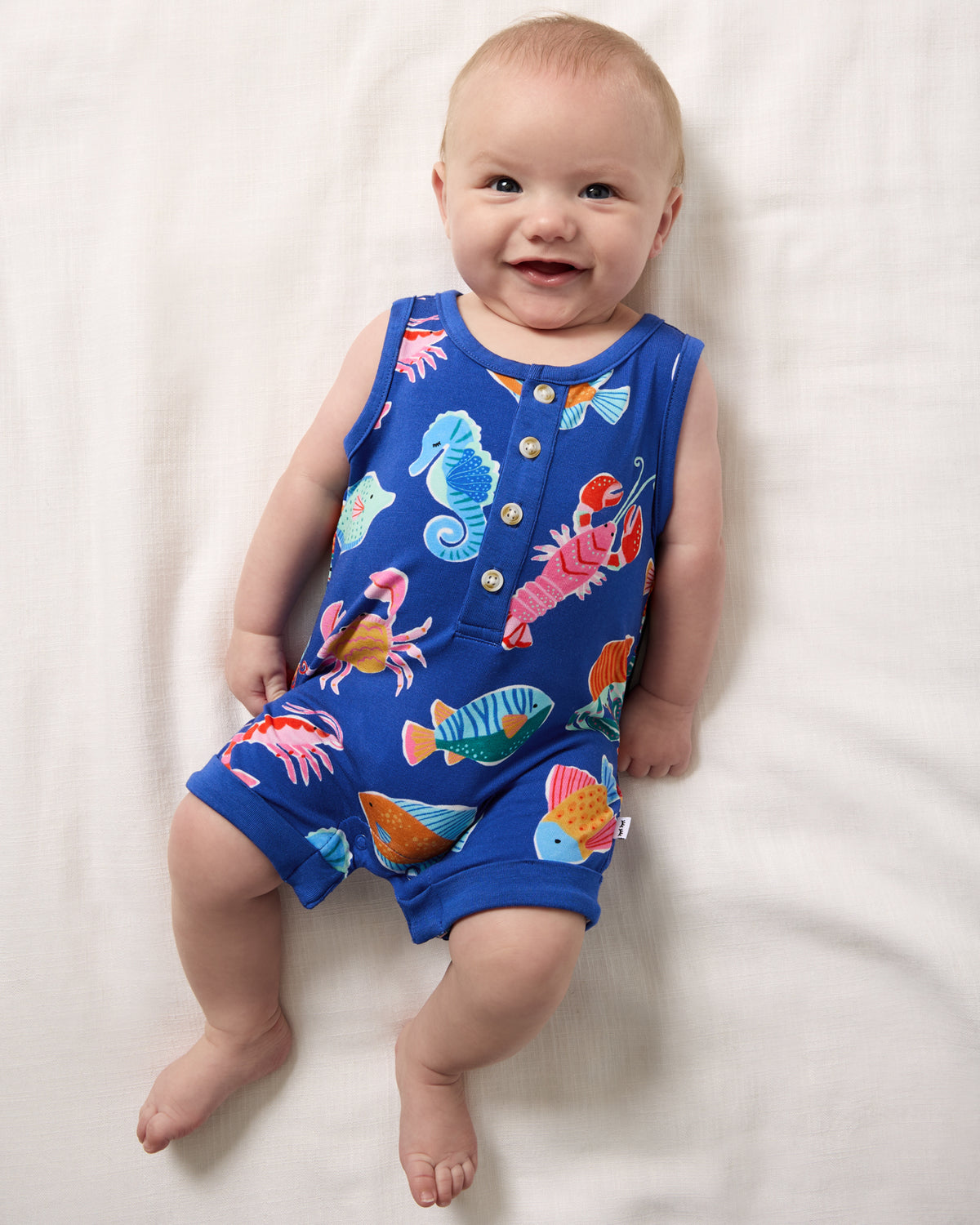 Aerial view of baby wearing the Tidepool Party Henley Romper
