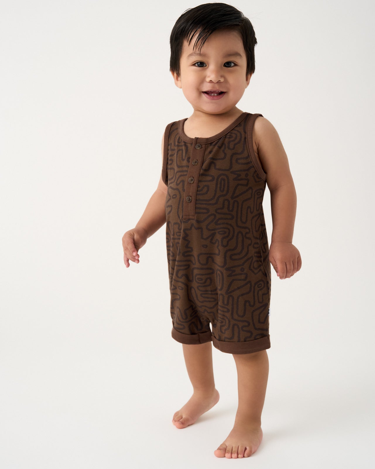 Toddler wearing the Dino Maze Henley Romper